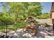 Expansive backyard with lush lawn, mature trees, a patio for entertaining, and a charming playhouse at 3397 Old Jonesboro Rd, Hapeville, GA 30354