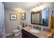 Bathroom with a granite countertop vanity and framed mirrors at 3397 Old Jonesboro Rd, Hapeville, GA 30354