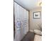 Bathroom featuring a shower with decorative tile and a framed print at 3397 Old Jonesboro Rd, Hapeville, GA 30354