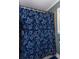 Bathroom featuring a blue patterned shower curtain and neutral tiling at 3397 Old Jonesboro Rd, Hapeville, GA 30354