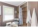 Bathroom with walk-in shower, neutral tiling, and natural lighting at 3397 Old Jonesboro Rd, Hapeville, GA 30354