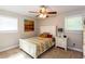 Cozy bedroom features a plush bed, ceiling fan, and ample natural light from windows at 3397 Old Jonesboro Rd, Hapeville, GA 30354