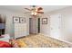 This is a cozy bedroom with a ceiling fan, a large dresser and two doors at 3397 Old Jonesboro Rd, Hapeville, GA 30354