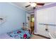 Bright bedroom with painted blue walls and an overhead ceiling fan at 3397 Old Jonesboro Rd, Hapeville, GA 30354