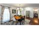 Cozy dining area showcasing hardwood floors, modern chandelier, and inviting ambiance at 3397 Old Jonesboro Rd, Hapeville, GA 30354
