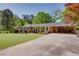 Traditional brick home with an attached carport, long driveway, and a beautifully landscaped front yard at 3397 Old Jonesboro Rd, Hapeville, GA 30354