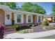 Inviting front entrance with brick steps, decorative door, and beautifully planted flowerbeds at 3397 Old Jonesboro Rd, Hapeville, GA 30354