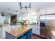 Well-lit kitchen with white cabinets, stainless steel appliances, and a view into the adjacent living area at 3397 Old Jonesboro Rd, Hapeville, GA 30354