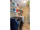 Laundry room with a front load washer/dryer, storage shelves, and tile flooring at 3397 Old Jonesboro Rd, Hapeville, GA 30354