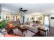 Open-concept living room with hardwood floors, ceiling fan, and views of the kitchen and dining area at 3397 Old Jonesboro Rd, Hapeville, GA 30354