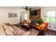 Comfortable living room with a stone fireplace, neutral-toned furniture, and natural light at 3397 Old Jonesboro Rd, Hapeville, GA 30354