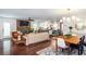 Open-concept living space with stone fireplace, hardwood floors, and seamless flow to the kitchen at 3397 Old Jonesboro Rd, Hapeville, GA 30354