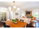 Open floor plan combining dining and living areas, with a view of the stone fireplace at 3397 Old Jonesboro Rd, Hapeville, GA 30354