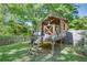 A cute wooden backyard playhouse with a slide adds charm to the outdoor space at 3397 Old Jonesboro Rd, Hapeville, GA 30354