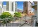 Balcony overlooking lush trees and city buildings at 44 Peachtree Nw Pl # 528, Atlanta, GA 30309