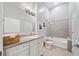 Bathroom with granite topped vanity, decorative lighting, neutral tiling, and shower/tub combo at 44 Peachtree Nw Pl # 528, Atlanta, GA 30309