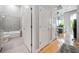 Bathroom with a tiled shower and tub, next to the hallway and kitchen area at 44 Peachtree Nw Pl # 528, Atlanta, GA 30309