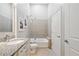 Bright bathroom featuring a granite vanity, neutral tile flooring, and a shower and tub at 44 Peachtree Nw Pl # 528, Atlanta, GA 30309