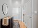 Entryway with dark console table, modern mirror, light gray walls, and hardwood floors at 44 Peachtree Nw Pl # 528, Atlanta, GA 30309