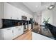 Kitchen featuring black countertops, white cabinetry, and stainless steel appliances at 44 Peachtree Nw Pl # 528, Atlanta, GA 30309