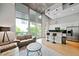 Spacious living area with high ceilings and a modern kitchen with stainless steel appliances at 44 Peachtree Nw Pl # 528, Atlanta, GA 30309