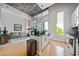 Open concept living area with large windows, island with sink, and hardwood floors at 44 Peachtree Nw Pl # 528, Atlanta, GA 30309
