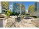 Outdoor dining area with a grill, tables, and lush greenery, ideal for gatherings at 44 Peachtree Nw Pl # 528, Atlanta, GA 30309