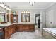 This spa-like bathroom boasts double sinks, granite counters, wood cabinetry and a soaking tub at 5422 Heyward Square Pl, Marietta, GA 30068