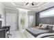 A bedroom with a gray accent wall, unique bed frame, tray ceiling and natural light at 5422 Heyward Square Pl, Marietta, GA 30068
