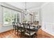 Elegant dining room with hardwood floors, chandelier, and large windows offering natural light at 5422 Heyward Square Pl, Marietta, GA 30068