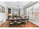 Elegant dining room with hardwood floors, chandelier, and large windows offering natural light at 5422 Heyward Square Pl, Marietta, GA 30068