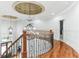 Elegant foyer showcases hardwood floors, ornate railing, and designer chandelier at 5422 Heyward Square Pl, Marietta, GA 30068
