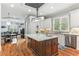 Open kitchen featuring an island with sink, stainless appliances, and views into the dining area at 5422 Heyward Square Pl, Marietta, GA 30068