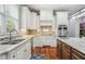 Bright kitchen boasting stainless steel appliances, mosaic backsplash and custom cabinetry at 5422 Heyward Square Pl, Marietta, GA 30068