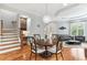 Open-concept living room and dining area with hardwood floors, modern lighting and neutral decor at 5422 Heyward Square Pl, Marietta, GA 30068