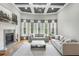 Bright living room featuring a fireplace, coffered ceiling, large windows, and comfortable seating at 5422 Heyward Square Pl, Marietta, GA 30068