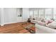 Beautiful living room with hardwood floors, neutral walls, comfortable sofa and built-in cabinet at 5422 Heyward Square Pl, Marietta, GA 30068