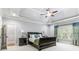 This home's large main bedroom features a ceiling fan, trey ceiling and ensuite access at 5422 Heyward Square Pl, Marietta, GA 30068