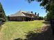 Expansive backyard featuring a manicured lawn and outdoor patio at 187 Slate Dr, Buford, GA 30518