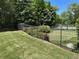 Beautifully landscaped backyard with flowerbeds, an iron fence, and a well-maintained lawn at 187 Slate Dr, Buford, GA 30518