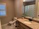 Well-lit bathroom featuring a granite-topped vanity and a patterned shower curtain at 187 Slate Dr, Buford, GA 30518