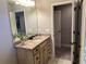 Bright bathroom with granite vanity, decorative mirror, and open doorway at 187 Slate Dr, Buford, GA 30518