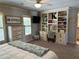 Comfortable bedroom featuring a ceiling fan, custom built-ins, and soft lighting, creating a relaxing and inviting space at 187 Slate Dr, Buford, GA 30518