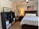 Bedroom featuring a ceiling fan, comfortable bed, and shelving for storage at 187 Slate Dr, Buford, GA 30518