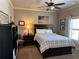 Comfortable bedroom with dark wood furnishings, ceiling fan, and bright natural light at 187 Slate Dr, Buford, GA 30518