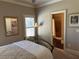 Bedroom highlighting a mirror, bedside lamp, and view into bathroom at 187 Slate Dr, Buford, GA 30518