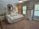 Cozy bedroom with plush bedding, shuttered windows, and a decorative mirror, creating a serene retreat at 187 Slate Dr, Buford, GA 30518
