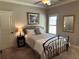 Cozy bedroom showcasing a wrought iron bed frame and shuttered window at 187 Slate Dr, Buford, GA 30518