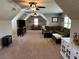 Bonus room with high angled ceilings, two ceiling fans, and lots of seating space at 187 Slate Dr, Buford, GA 30518