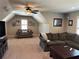 Bonus room with sofa, tv and ceiling fan, perfect for relaxation and entertainment at 187 Slate Dr, Buford, GA 30518